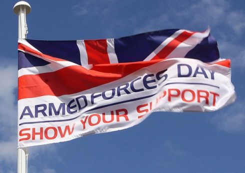 Armed Forces Day flag on a mast with Show Your Support strapline