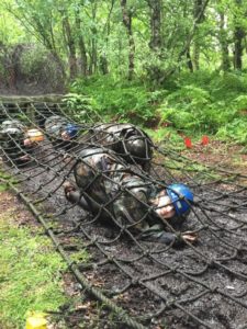 Cadets enjoy crawling through muddy assault course