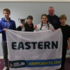 Lesley with Eastern region sports cup while cadets hold up flag