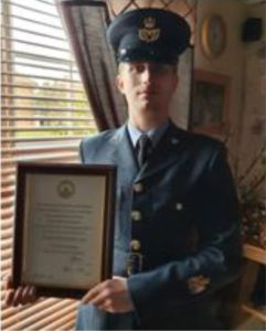NAthan Eyre with his Meritorious Service Certificate