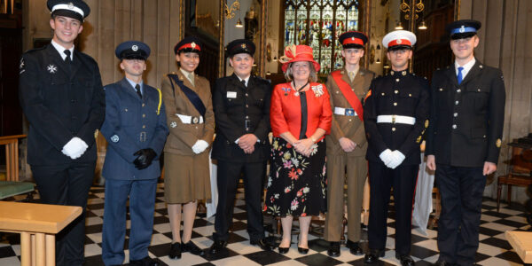 Helen Nellis setands with her appointed cadets around her in the cathedral