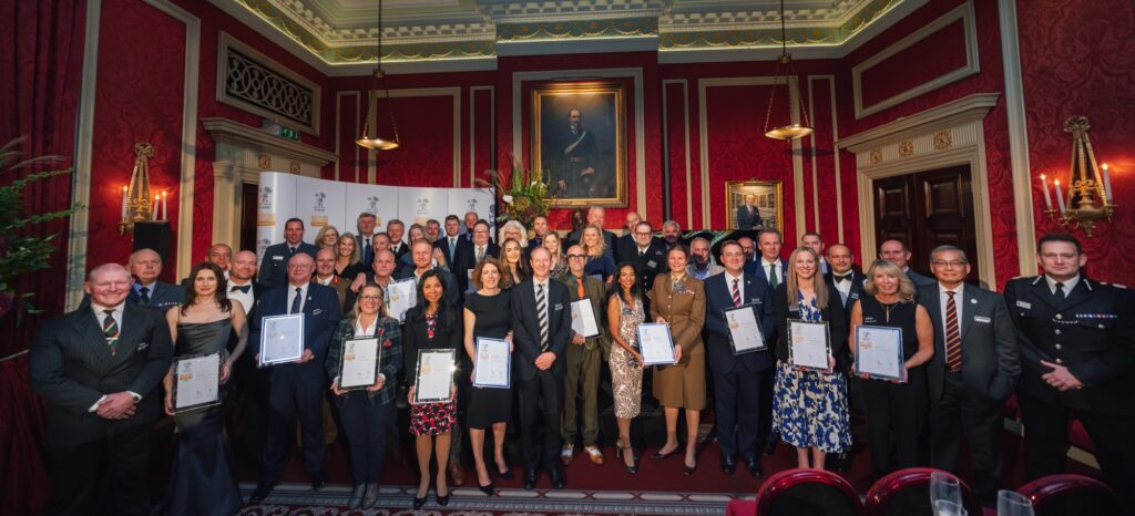 All the London and Eastern region gold ERS winners stan together at the Royal Automobile Club in London holding their framed certificates.