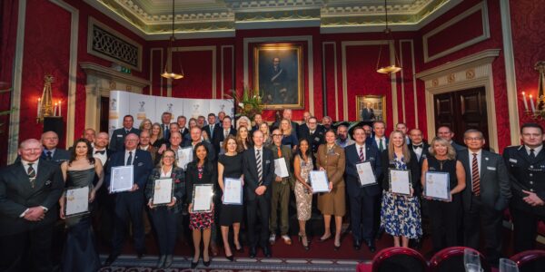 All the London and Eastern region gold ERS winners stan together at the Royal Automobile Club in London holding their framed certificates.