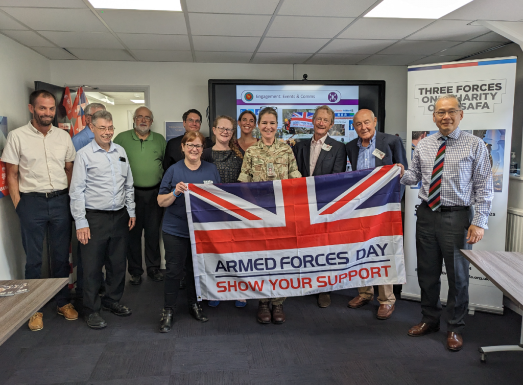 Staff holding the Armed Forces Day flag for Reserves Day 2023