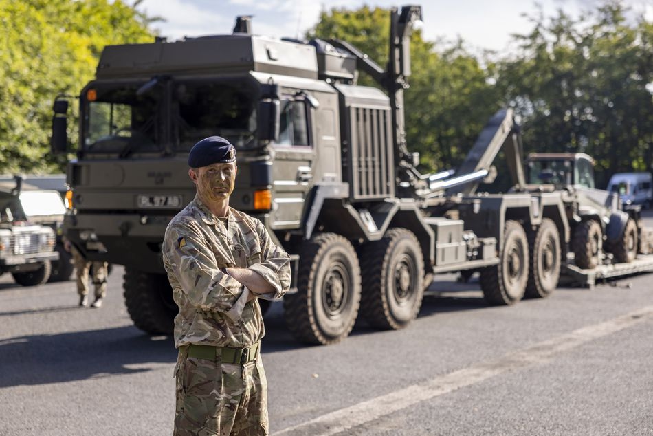 Private Gusterson in reservist uniform outside in front of his army vehicle