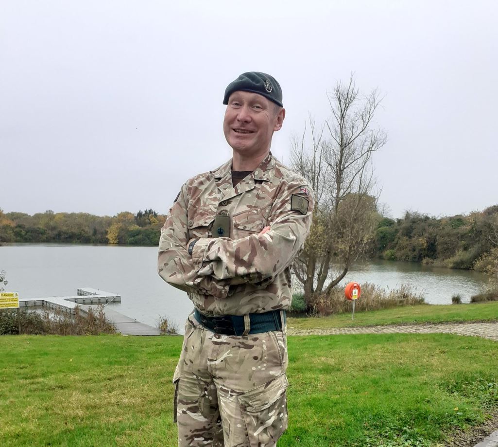Lt Col Matt Helsby stands in front of the lake at Coldhams Lane Army Reserve Centre in Cambridge