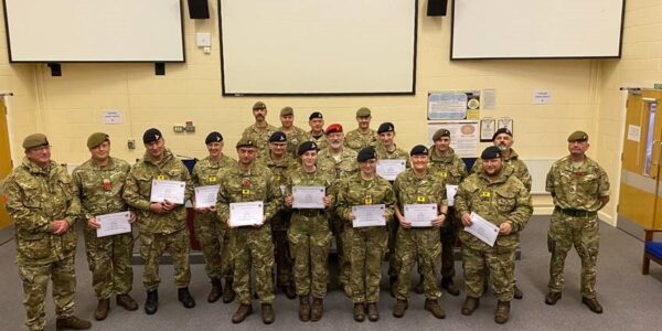 Newly qualified adult instructors stand as a group with their certificates
