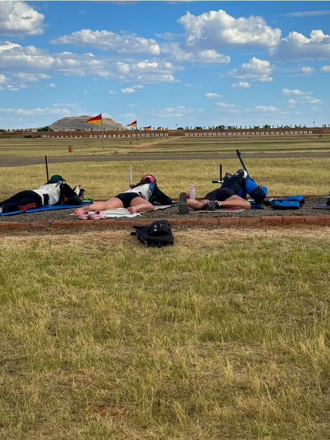 shooters laying on the ground aiming at ranges far off in the distance during the long range shooting competition